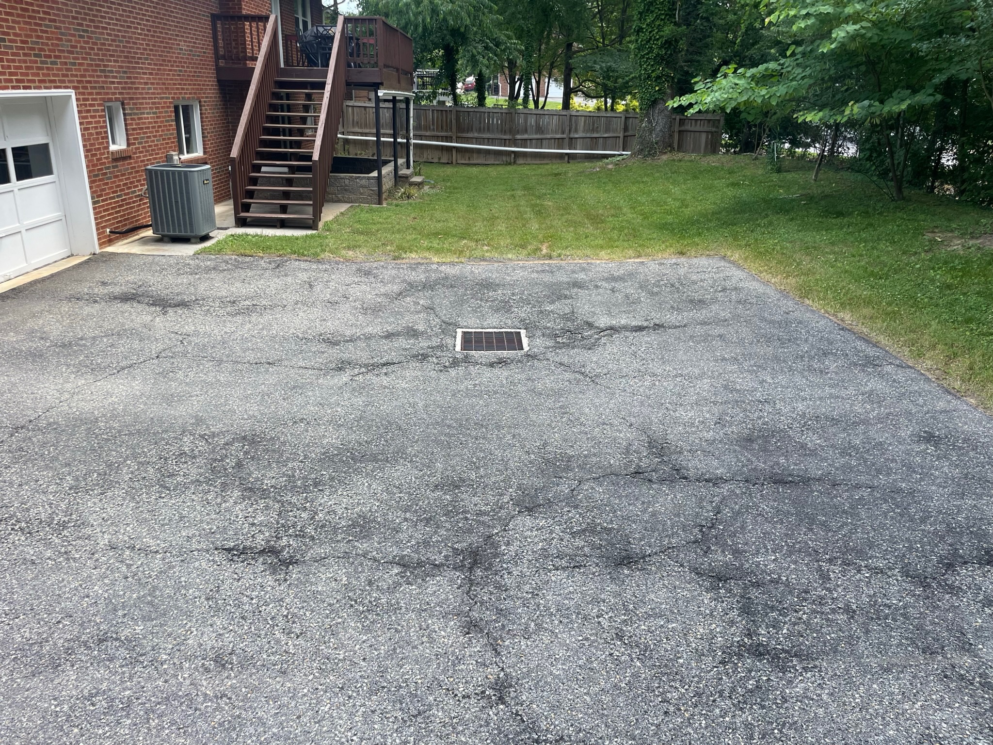 Faded asphalt driveway before sealcoating